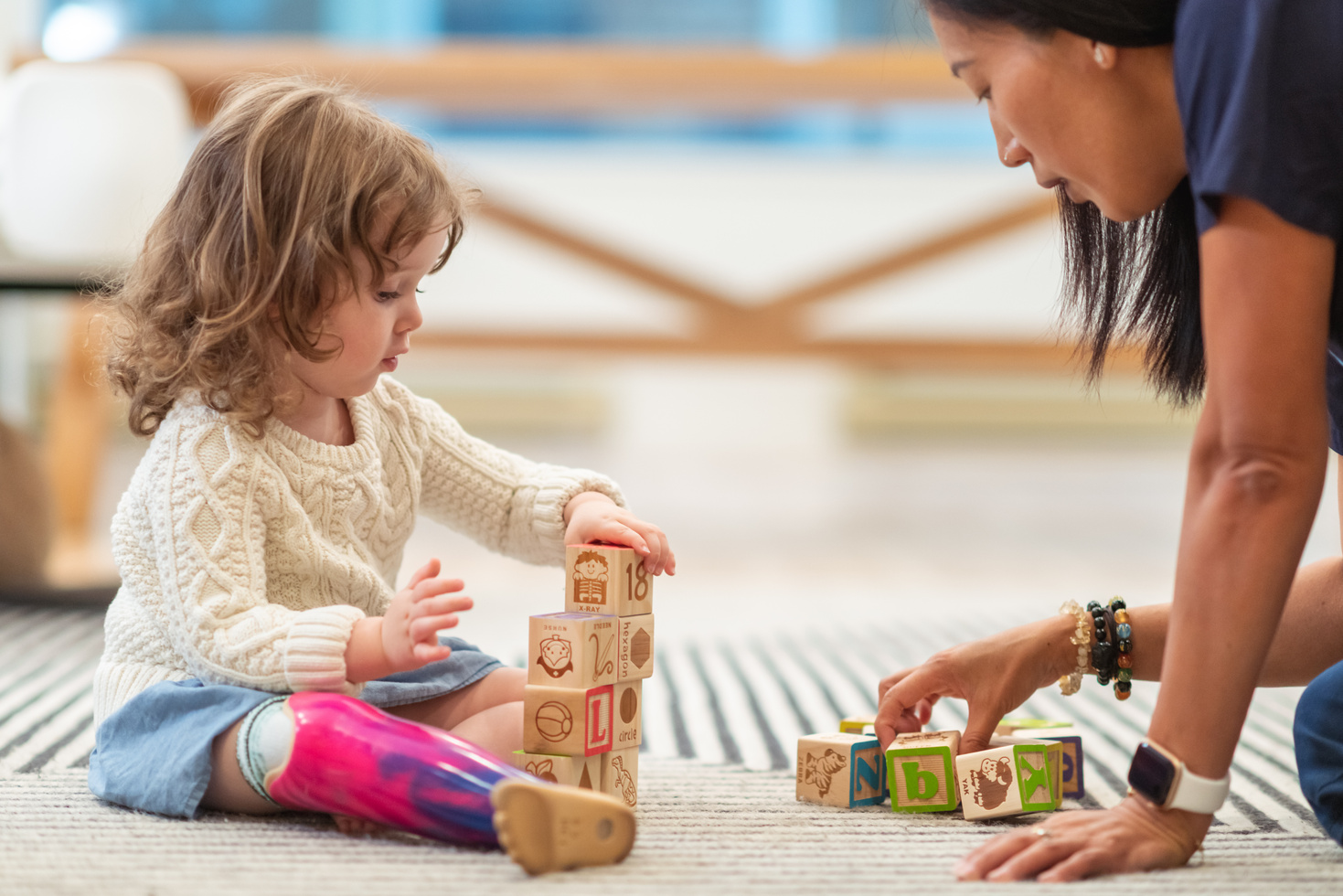 Little girl with prosthetic leg at occupational therapy appointment